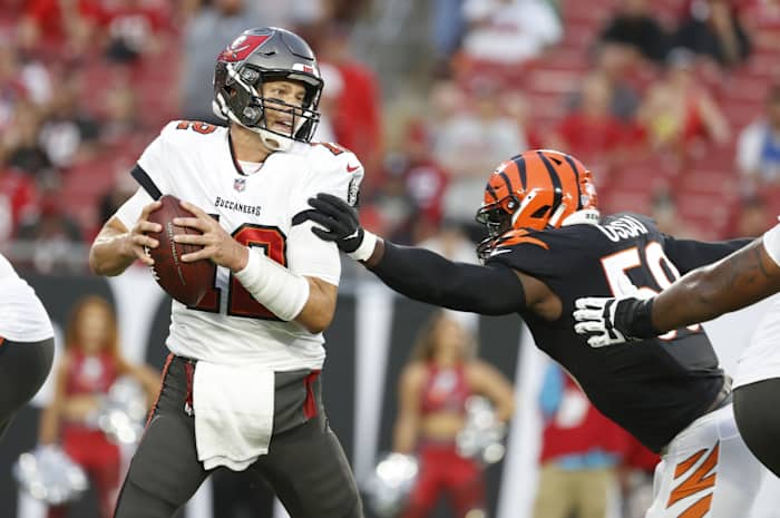 Aug 14, 2021; Tampa, Florida, USA; Cincinnati Bengals defensive end Joseph Ossai (58) tackles Tampa Bay Buccaneers quarterback Tom Brady (12) during the first quarter at Raymond James Stadium. Mandatory Credit: Kim Klement-USA TODAY Sports
